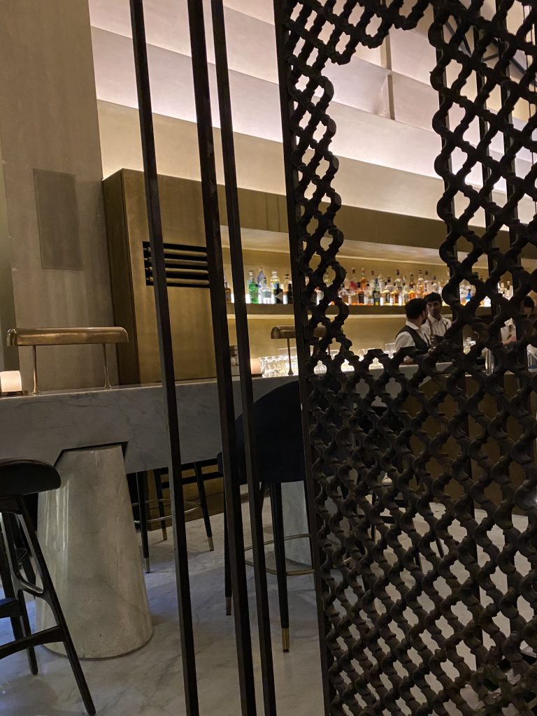 View of bar through ornamental lattice at masque restaurant mumbai