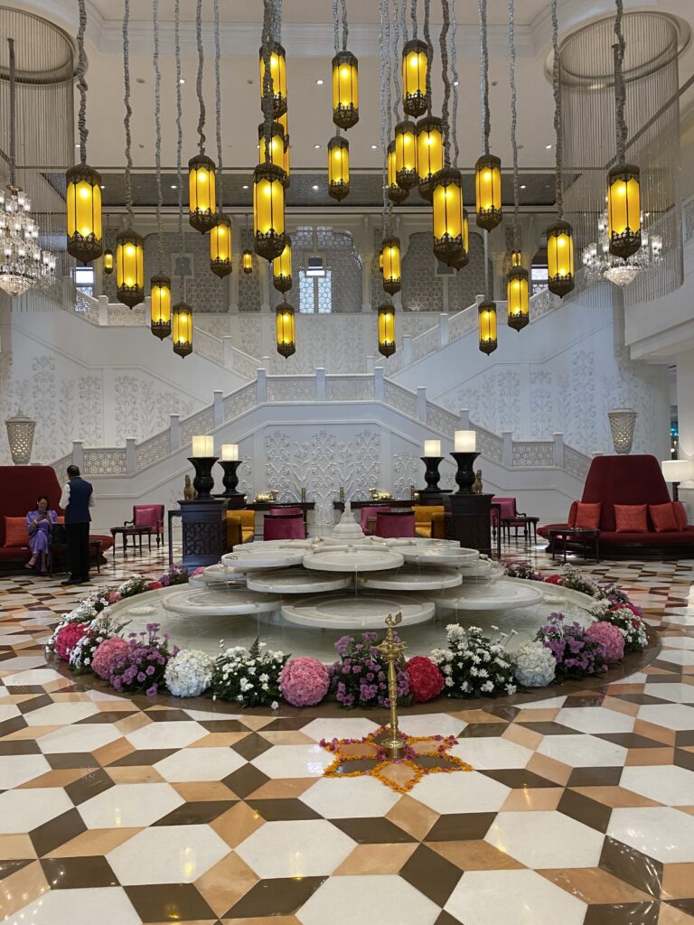 Hotel lobby of the ITC Rajputana Hotel in Jaipur, India with mosaic floors and pendant lights